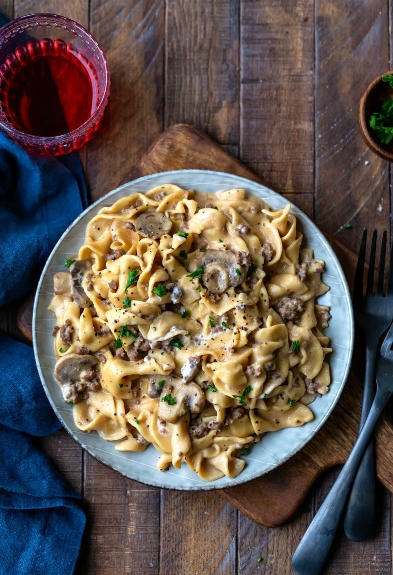 Blue plate with Instant Pot Beef Stroganoff next to two black forks