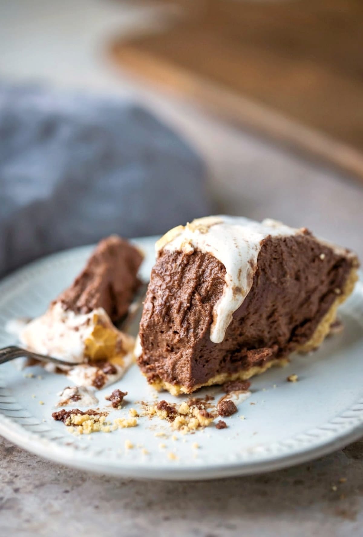 Slice of s'mores pie with a bite next to it on a fork.