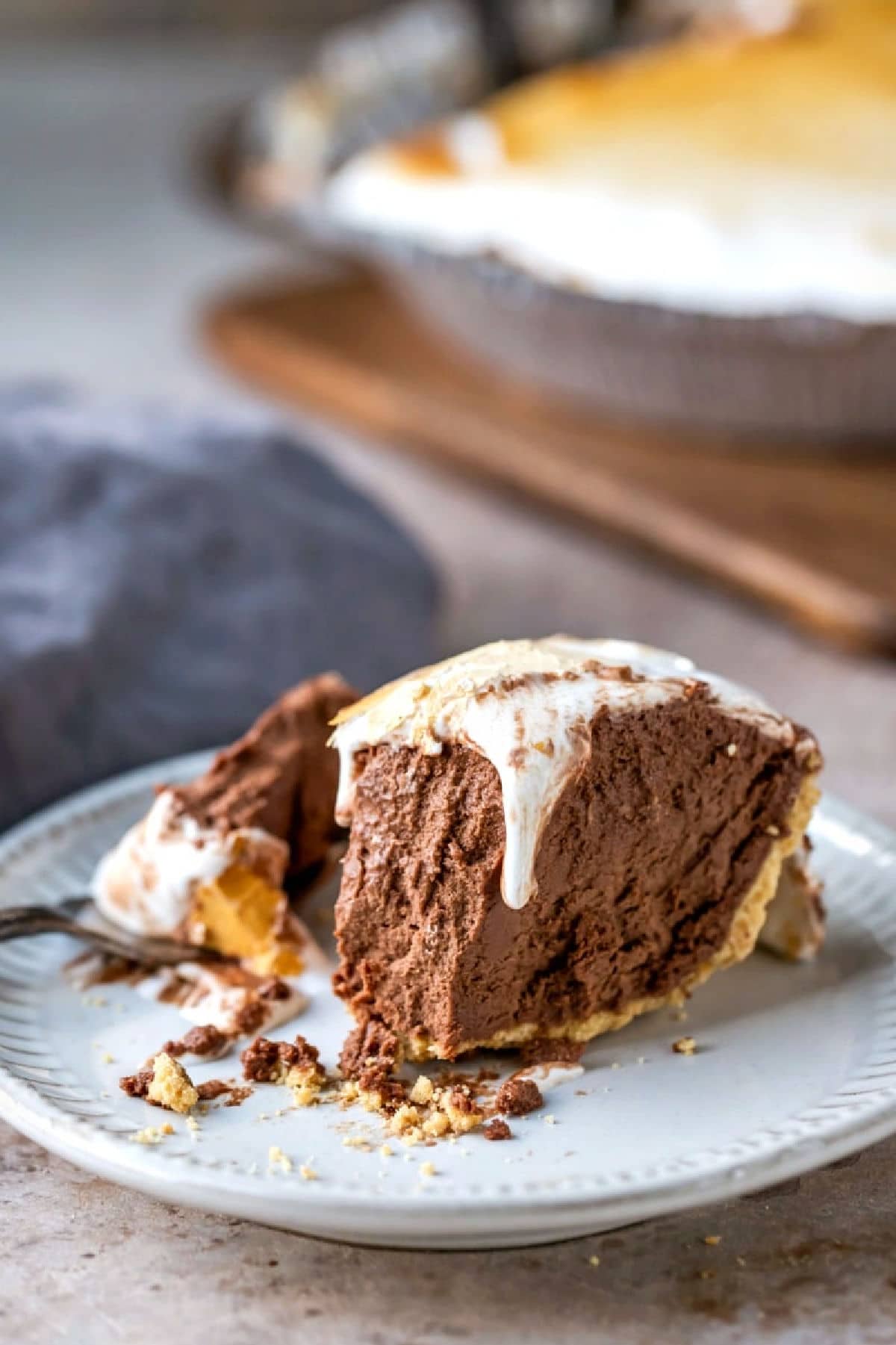 Slice of s'mores pie on a cream plate.