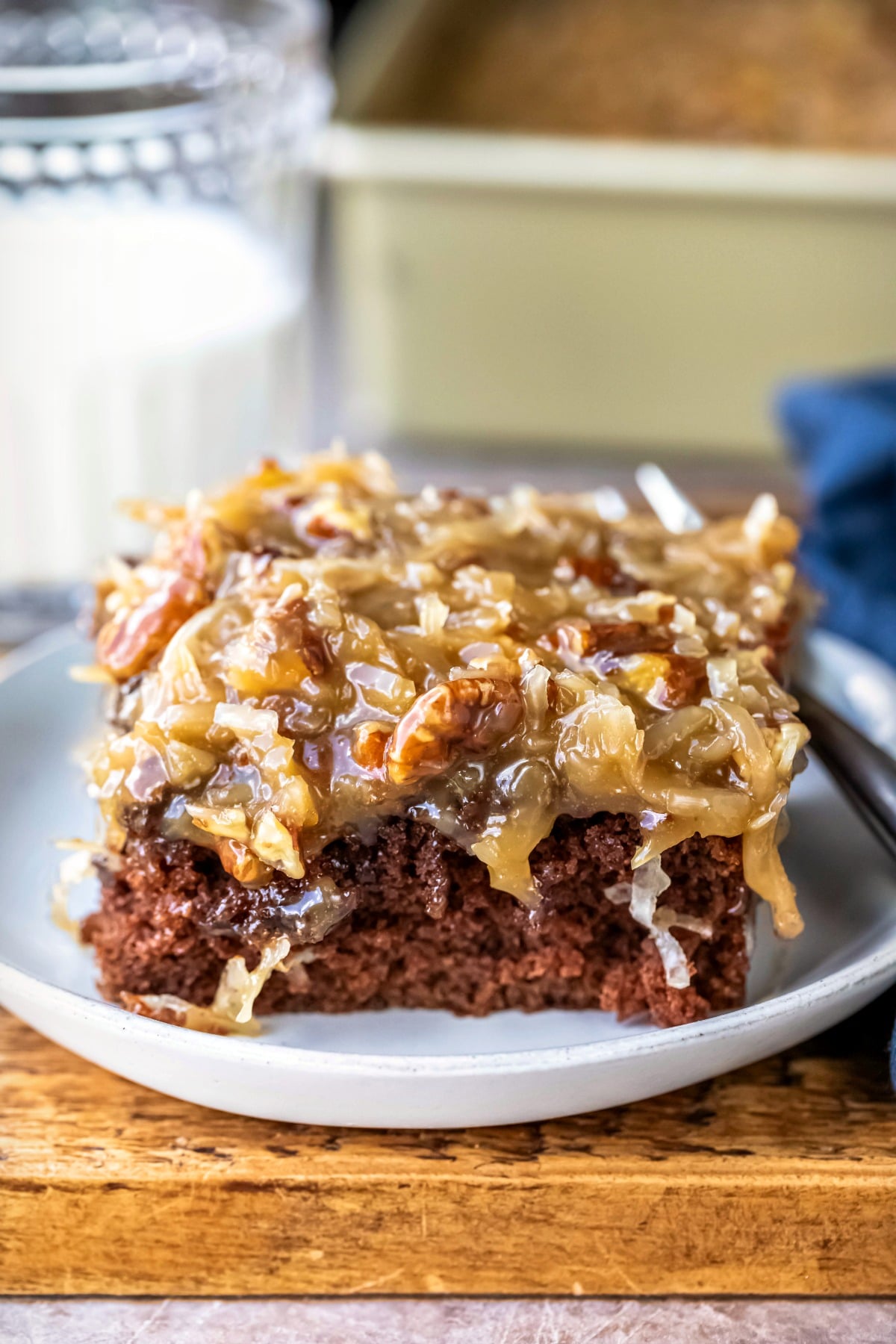 Piece of German chocolate sheet cake on a white plate