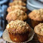 Apple muffins next to a blue linen napkin