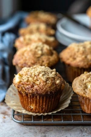 Apple muffins next to a blue linen napkin