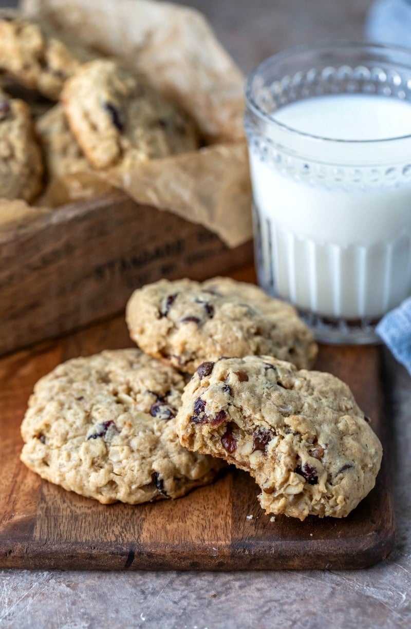 Three breakfast cookies next to a glass of milk