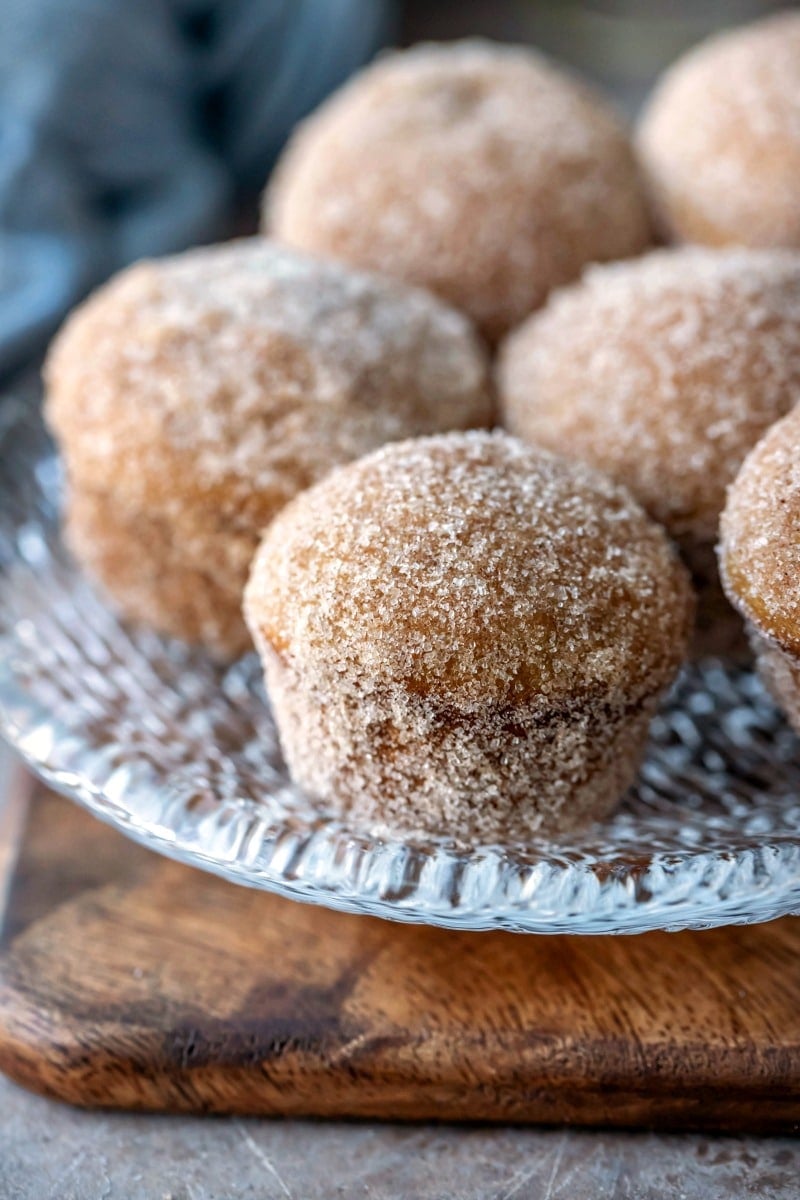 Apple cider donut muffins on a glass plate
