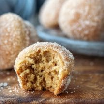 Apple cider donut muffins on a wooden cutting board