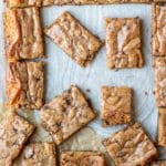 Partially cut tray of blondies on parchment paper
