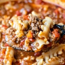 Scoop of lasagna soup on a black spoon