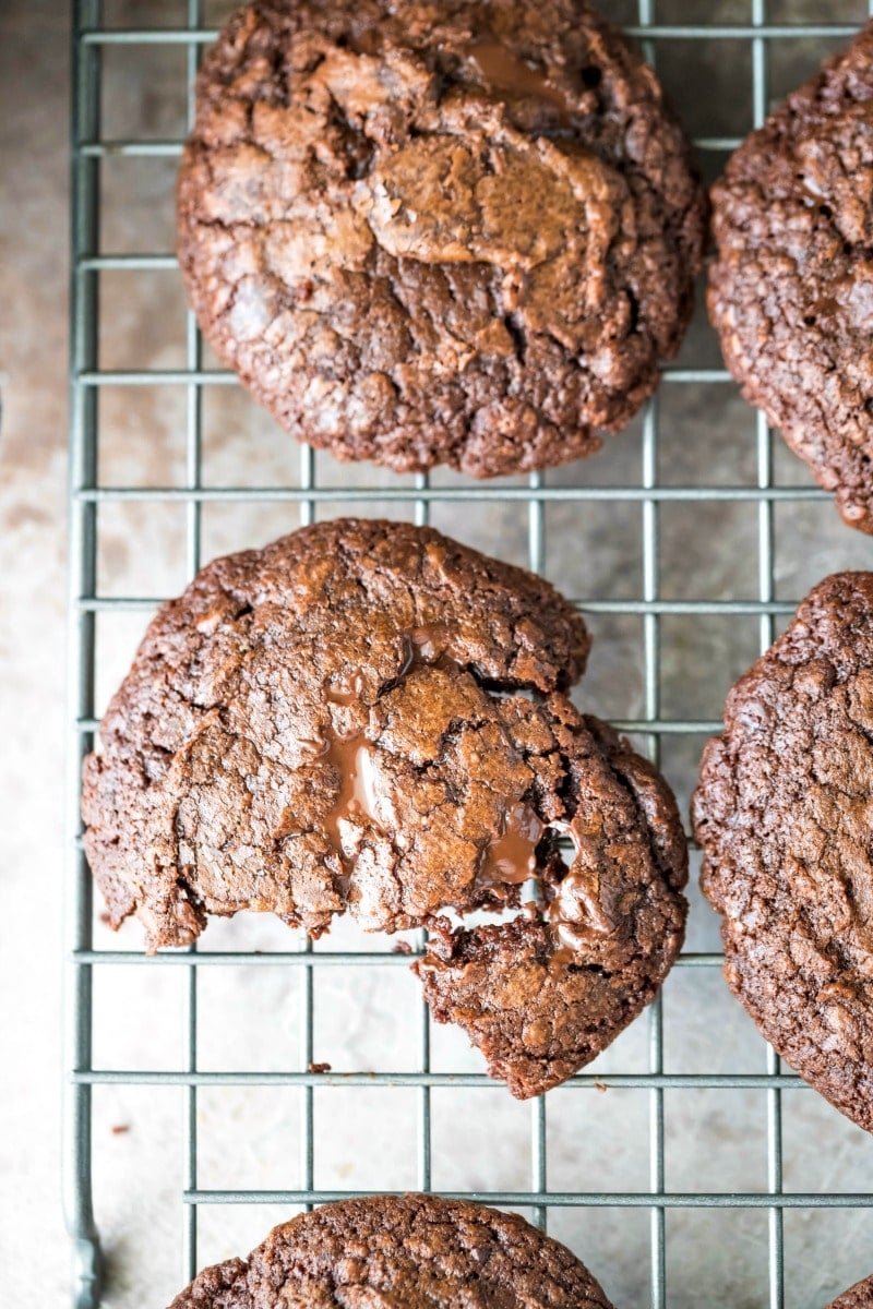 Broken apart chocolate fudge cookie on a wire cooling rack