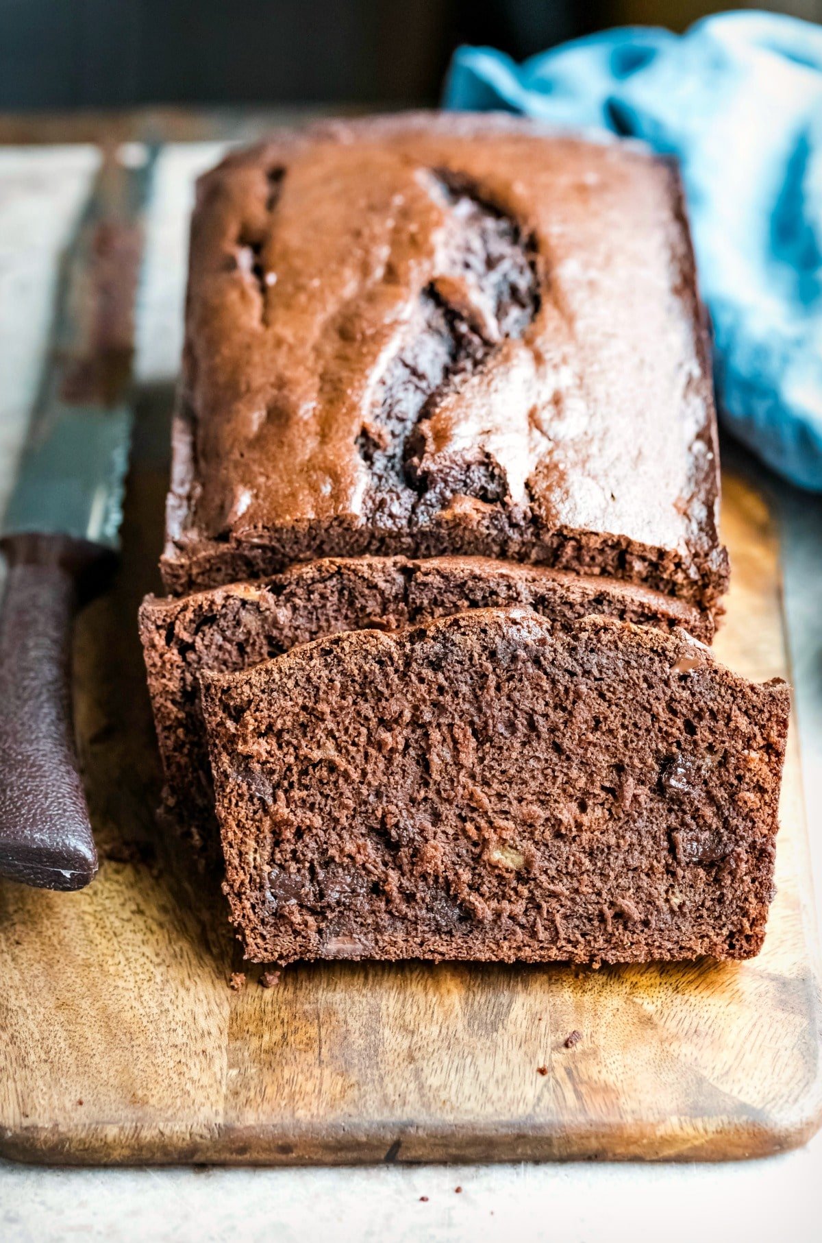 2 slices of chocolate banana bread leaning against the loaf
