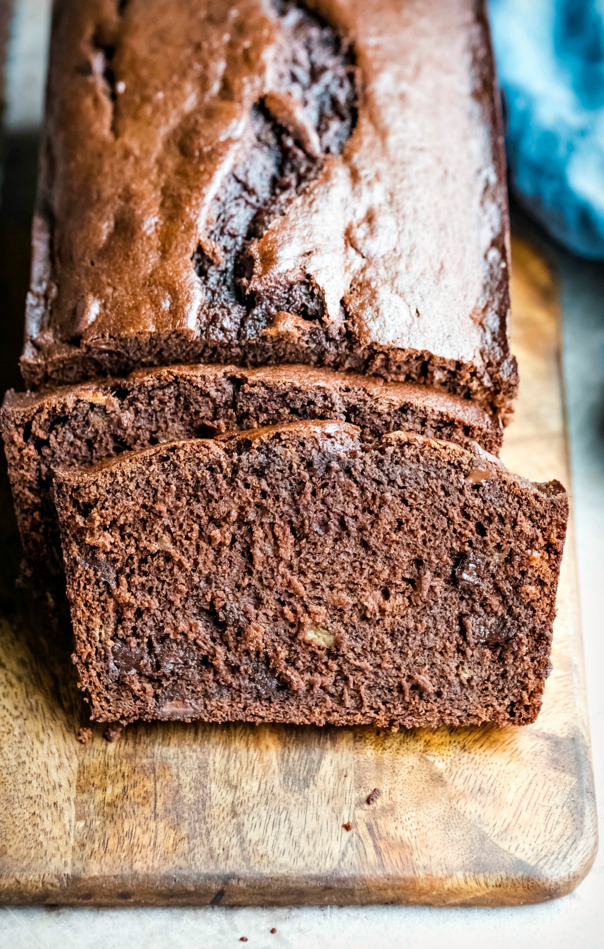 Loaf of chocolate banana bread with two slices cut from it
