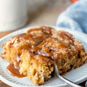Slice of cinnamon apple cake on a cream plate