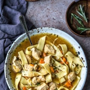 Speckled dish filled with homemade chicken noodle soup