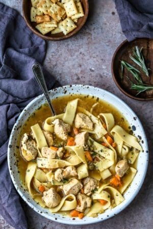 Speckled dish filled with homemade chicken noodle soup