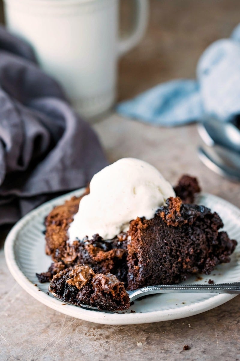 Slow cooker brownies topped with a scoop of vanilla ice cream