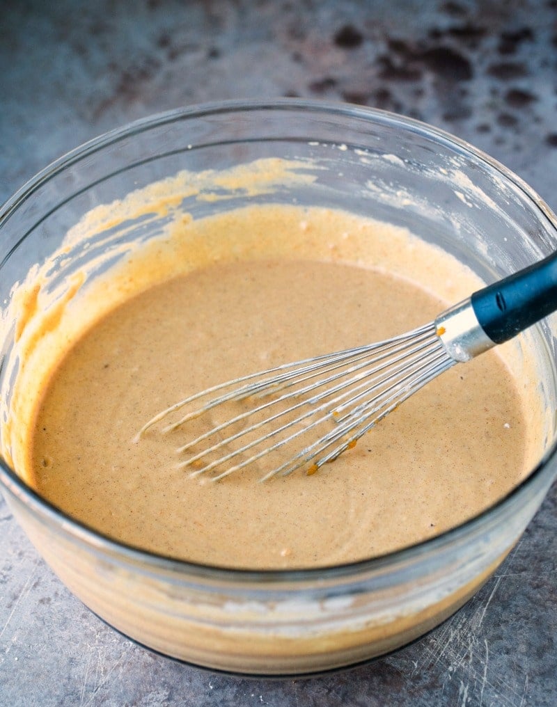 Pumpkin pancake batter with a whisk in it