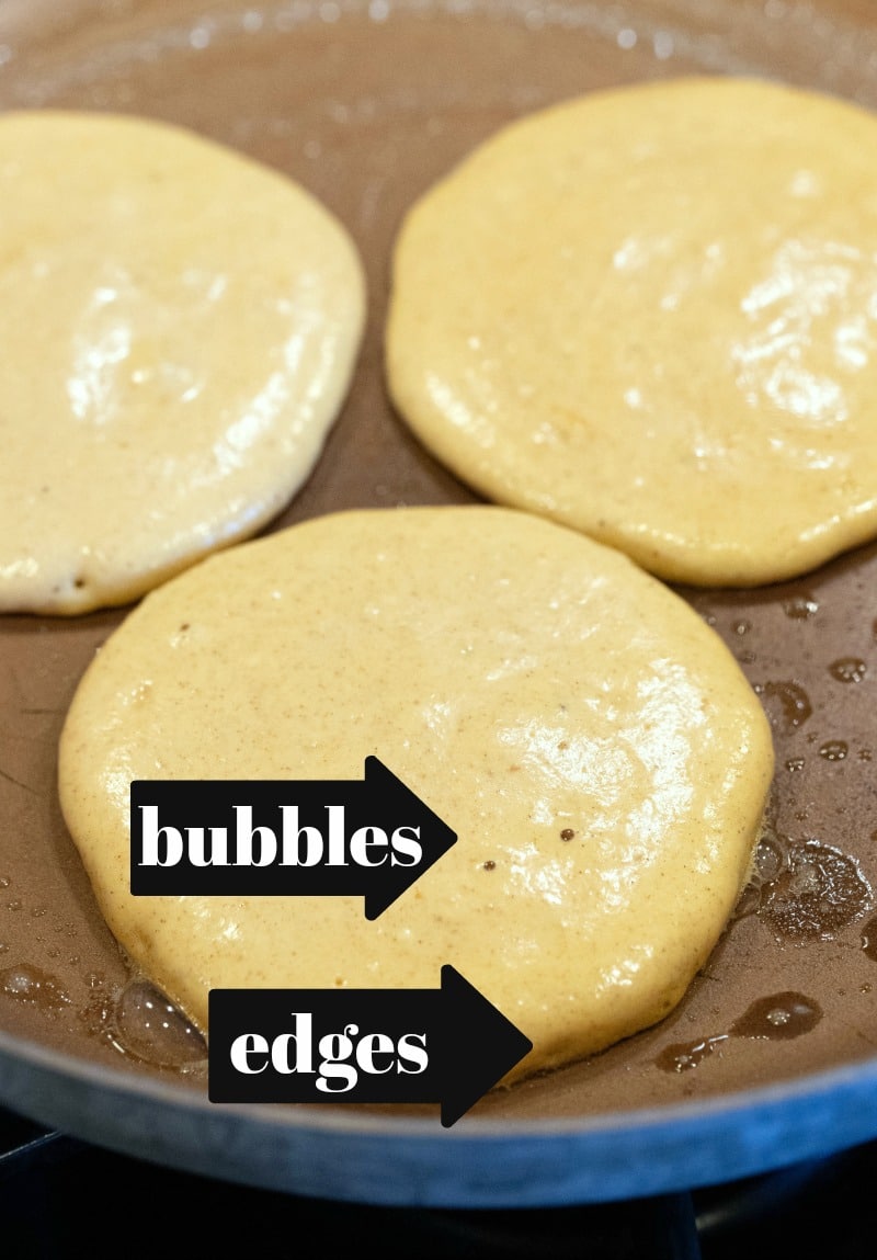 Pumpkin pancakes cooking in a copper skillet 