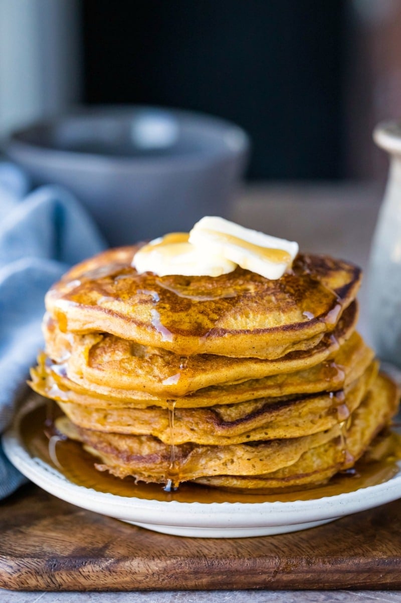 Stack of pumpkin pancakes with butter and syrup
