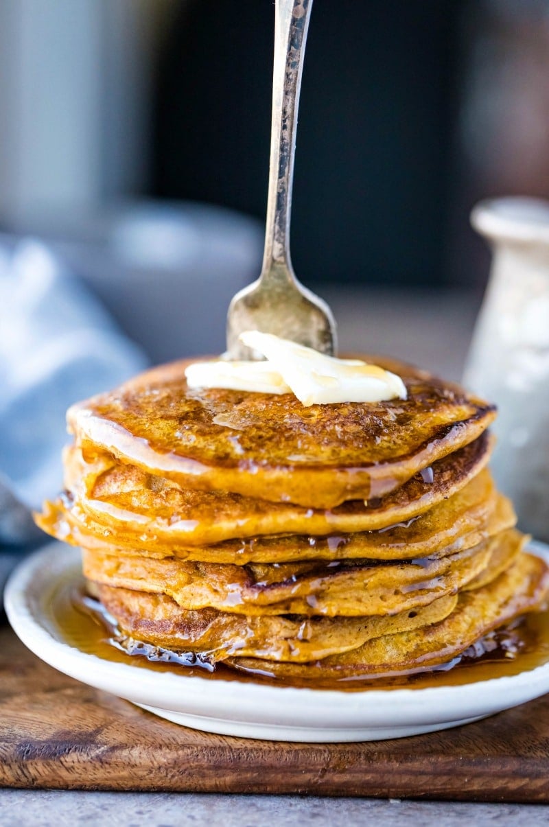 Stack of pumpkin pancakes with a fork in them