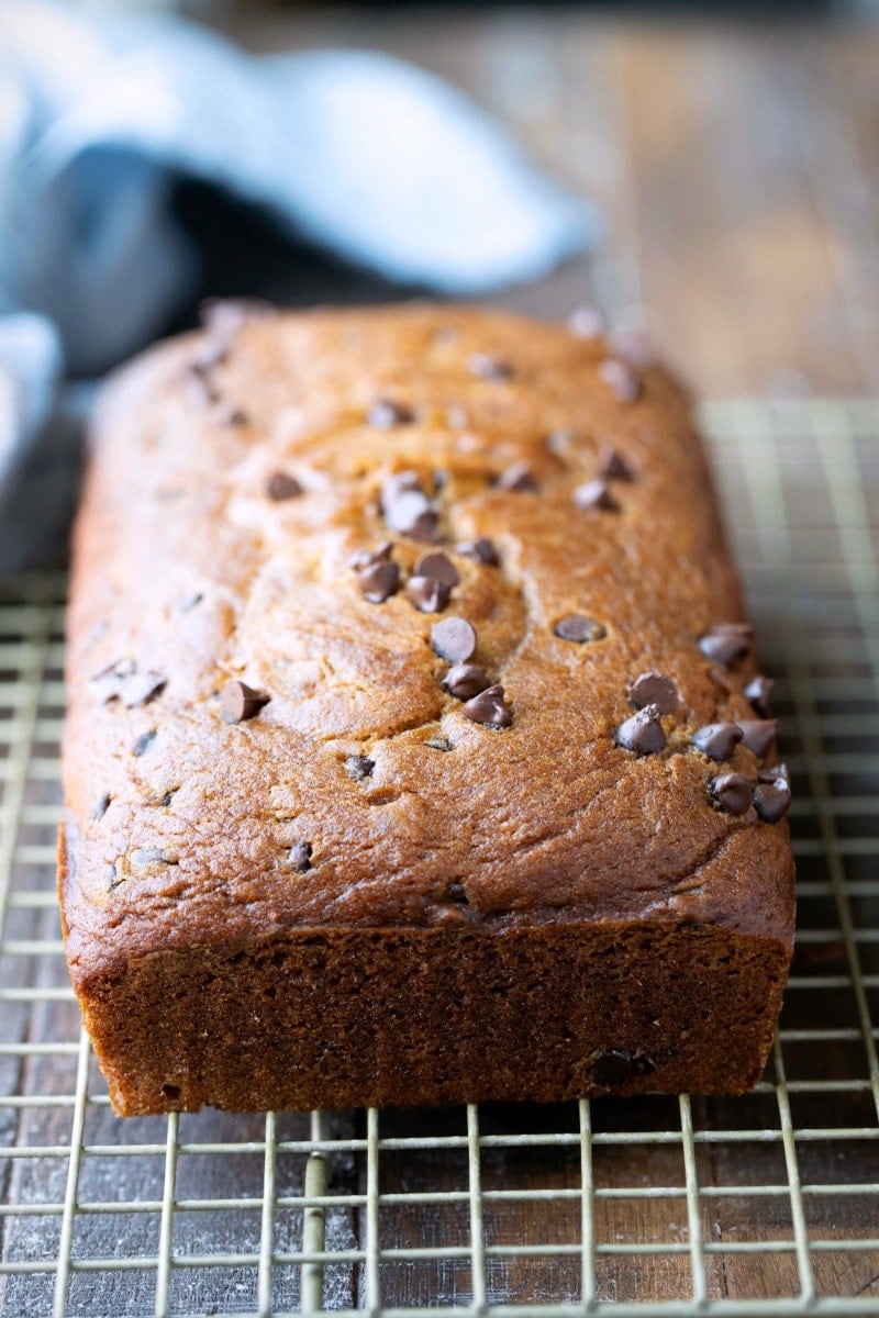 Loaf of pumpkin chocolate chip bread on a cooling rack