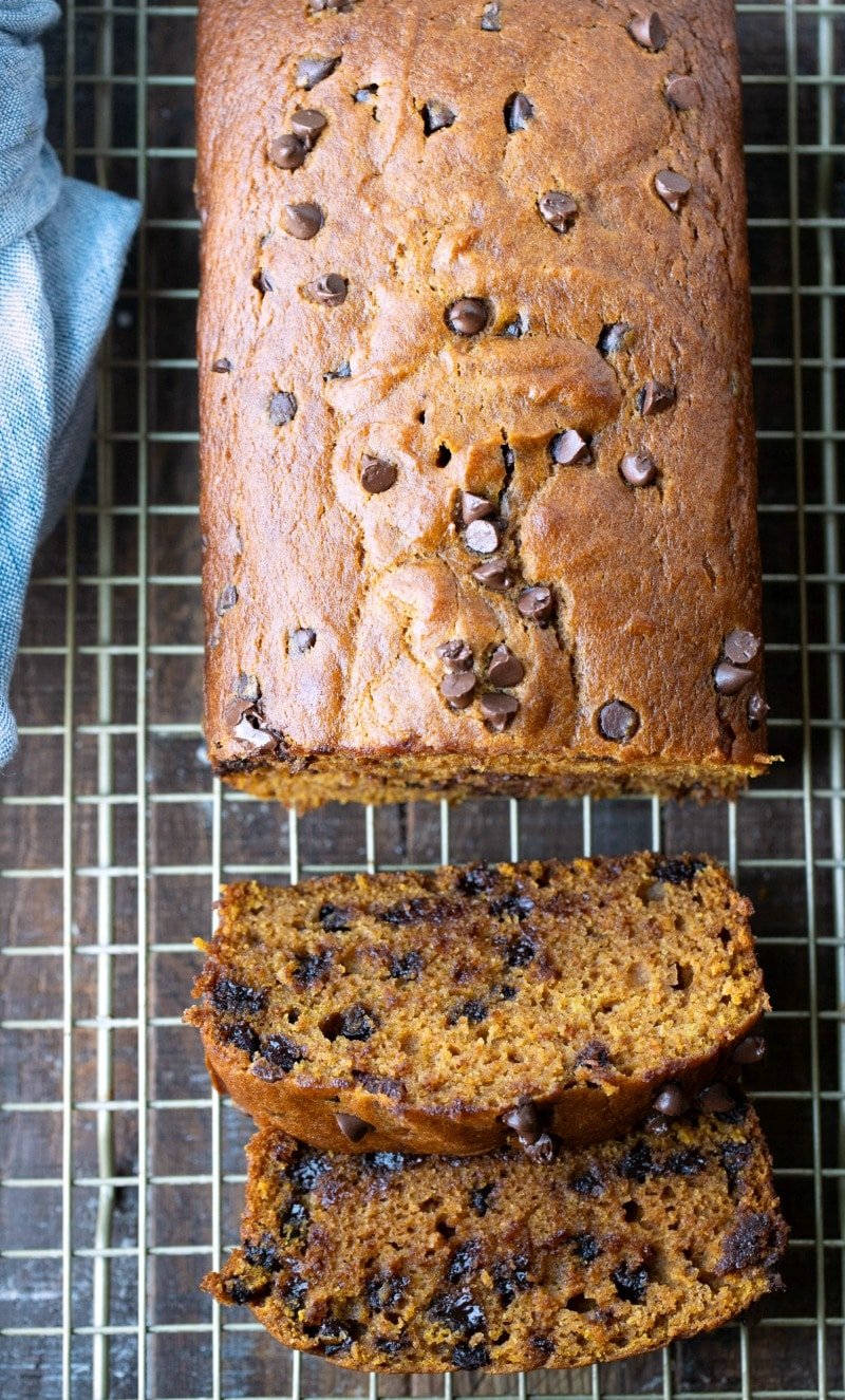 Sliced pumpkin chocolate chip bread on a gold wire cooling rack