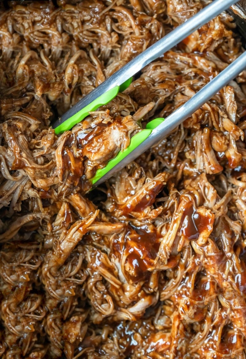 Crockpot pulled pork with barbecue sauce in a crockpot insert