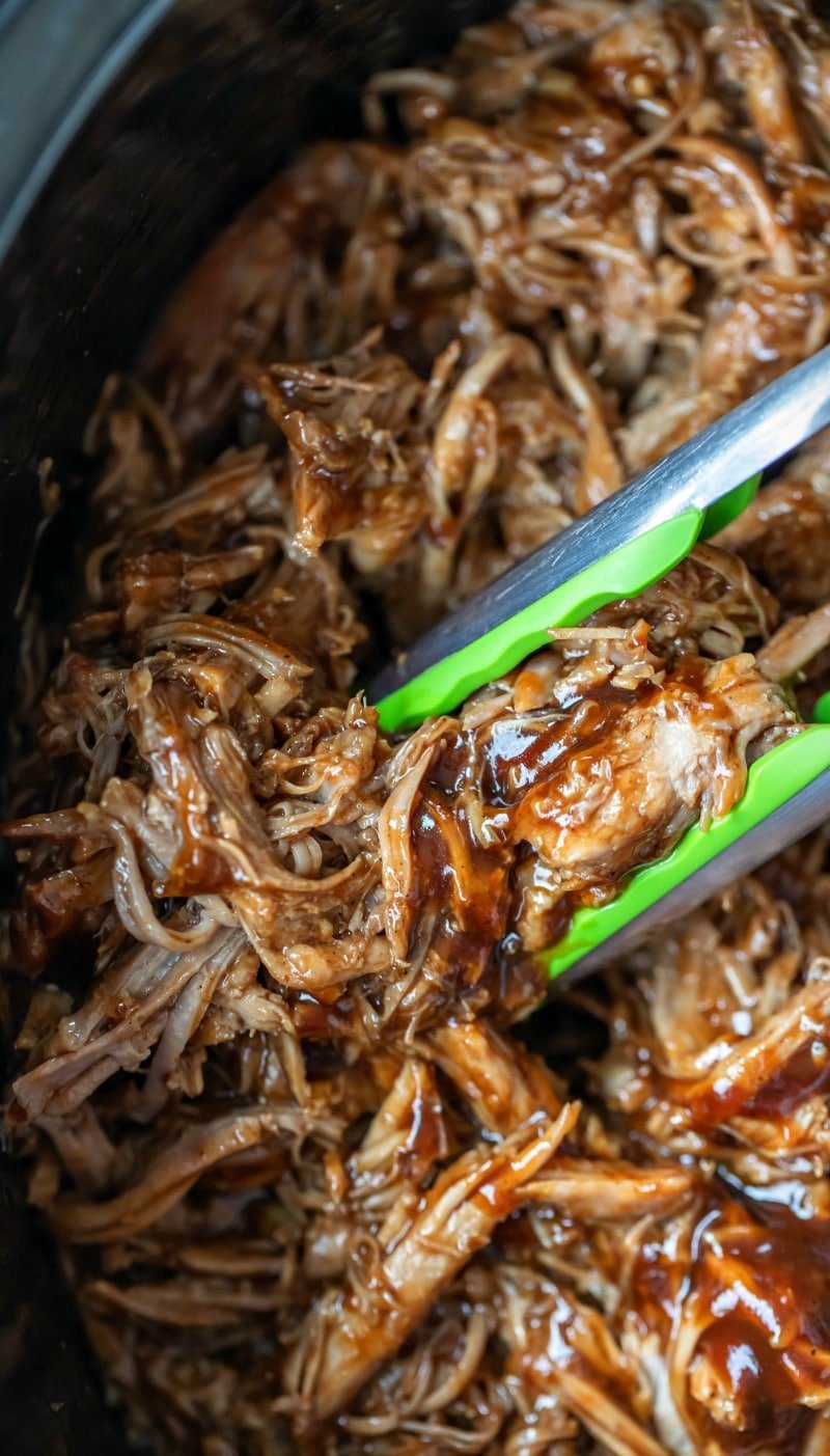 Crockpot pulled pork in a black crockpot insert