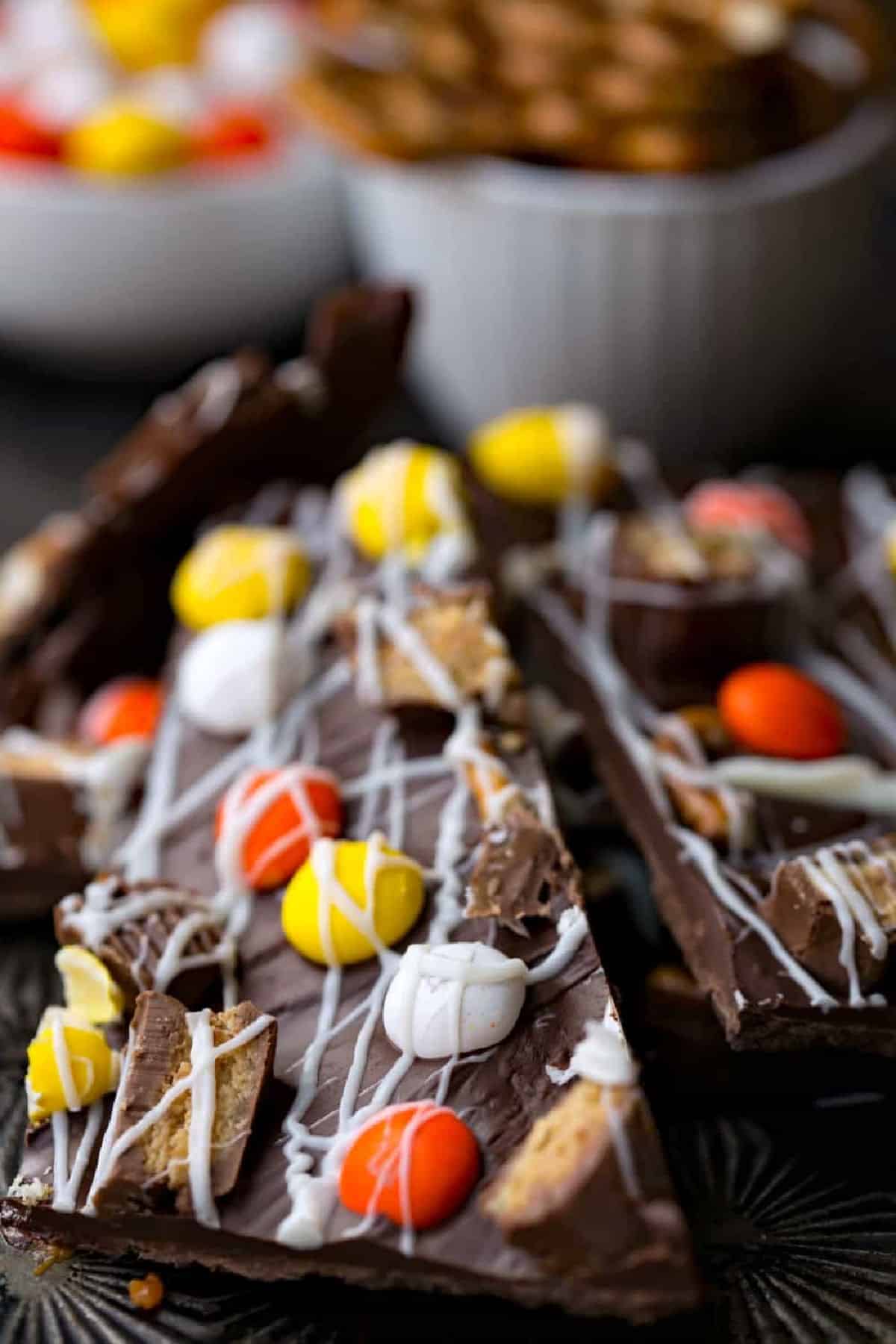 Halloween Bark Recipe Halloween Candy Bark in a stack on a baking sheet.