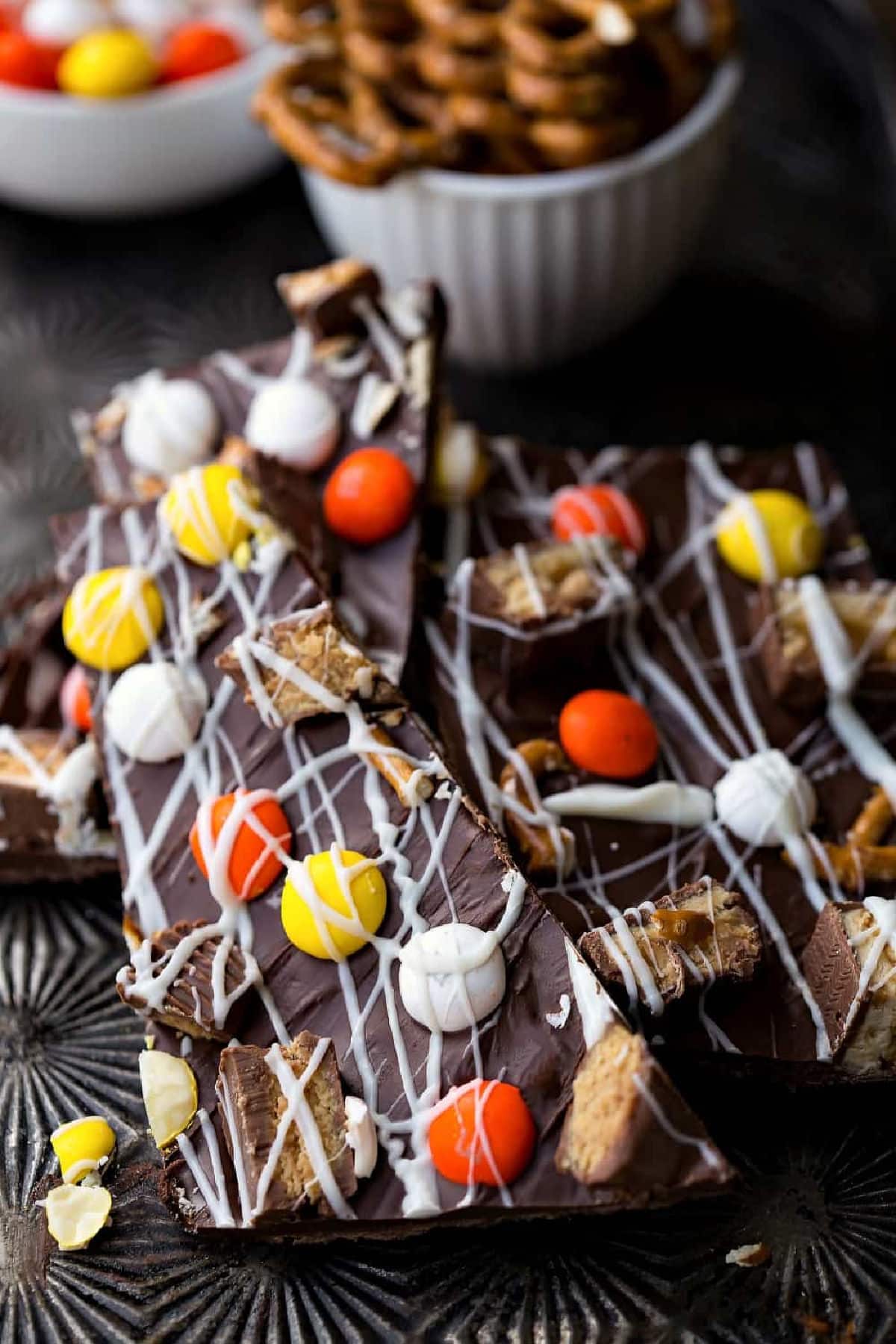 Pieces of Halloween candy bark on a vintage cookie sheet. 