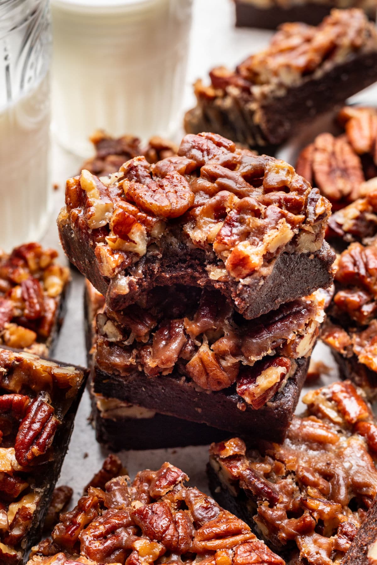 Pecan Pie Brownies A couple of pecan pie brownies in a stack with a bite missing from the top brownie.