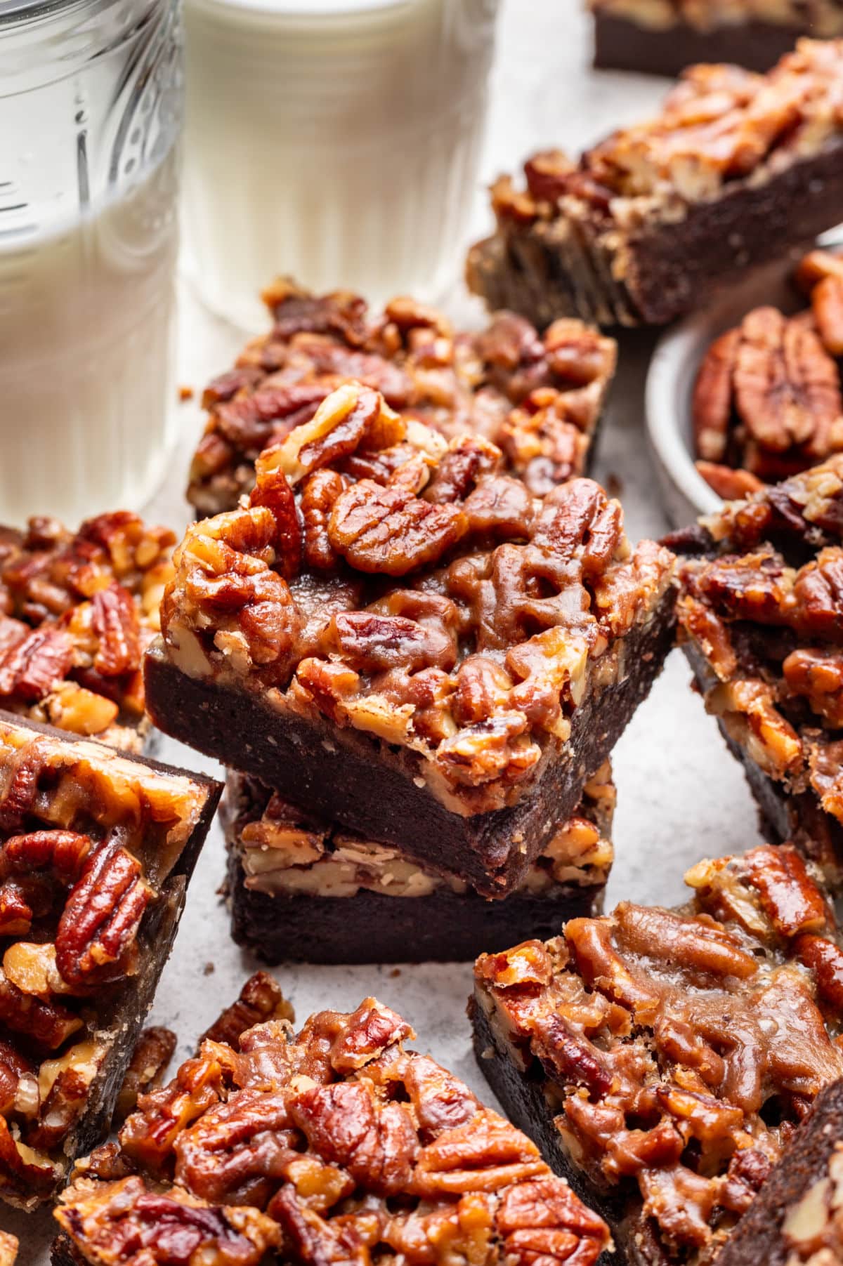 A couple of pecan pie brownies stacked on top of each other.