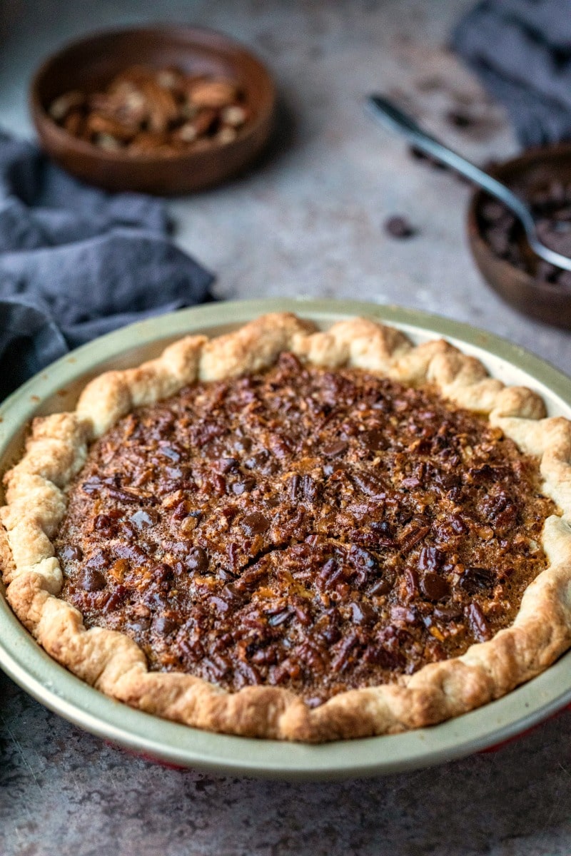 Close up photo of chocolate pecan pie next to a gray linen napkin