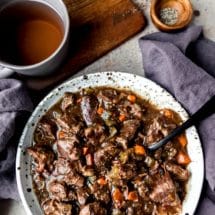Speckled pottery dish full of slow cooker beef bourguingon