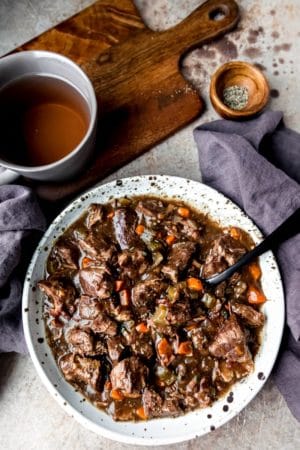 Speckled pottery dish full of slow cooker beef bourguingon