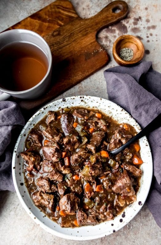 Speckled pottery dish full of slow cooker beef bourguingon