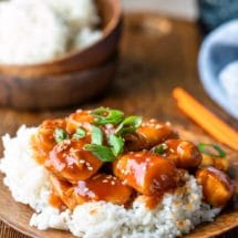 Easy orange chicken topped with sesame seeds and green onions