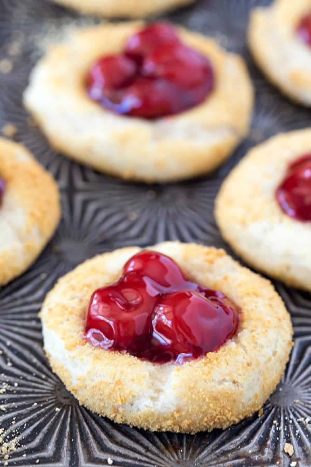 Cherry Cheesecake Thumbprint Cookies on a vintage baking sheet.