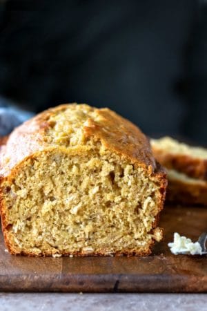 Butter knife with butter next to Banana Oatmeal Bread