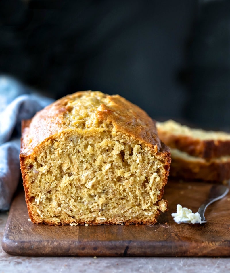 Butter knife with butter next to Banana Oatmeal Bread