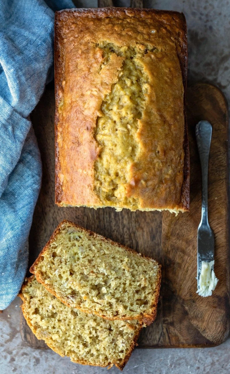 Overhead photo of sliced banana oatmeal bread on a wooden cutting board