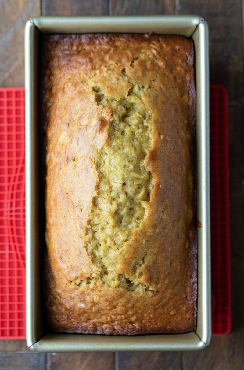 Baked banana oatmeal bread in a gold loaf pan