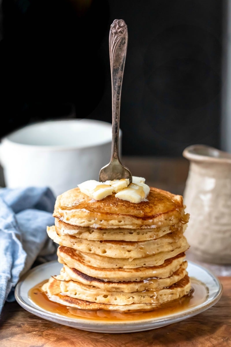 Stack of multigrain pancakes with a fork sticking out of them