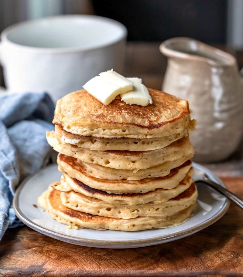 Stack of multigrain pancakes with pat of butter on top