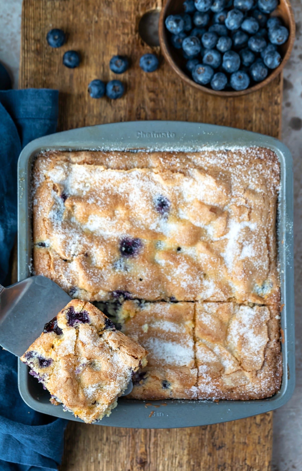 Slice of blueberry cake on a silver spatula