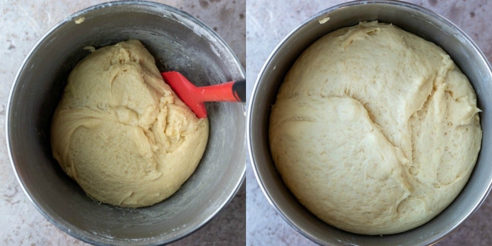 Risen cinnamon roll dough in a silver mixing bowl.