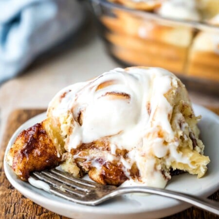 Homemade cinnamon roll with a bite on a fork