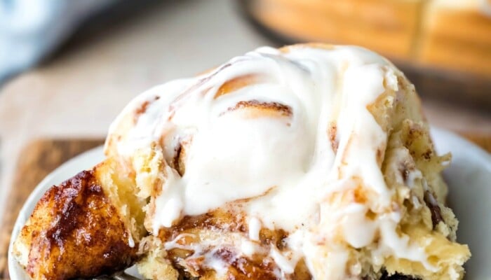 Homemade cinnamon roll with a bite on a fork