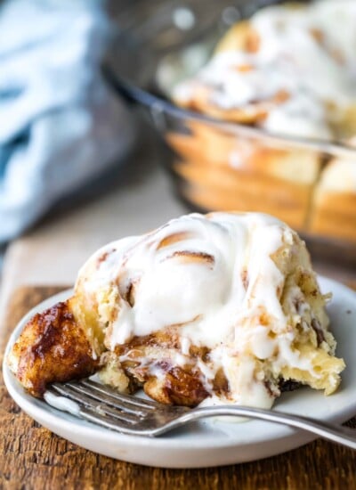 Homemade cinnamon roll on a white plate