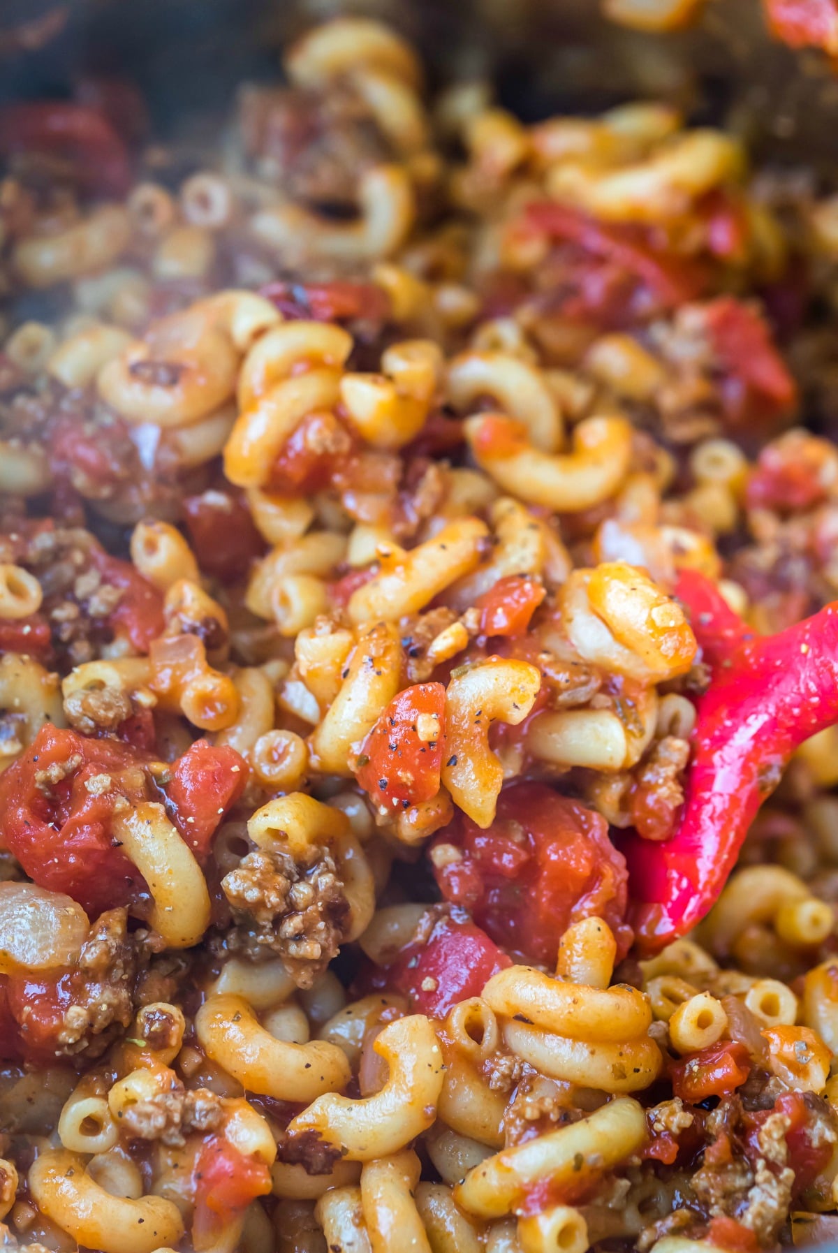 Pink spoon scooping up Instant Pot goulash