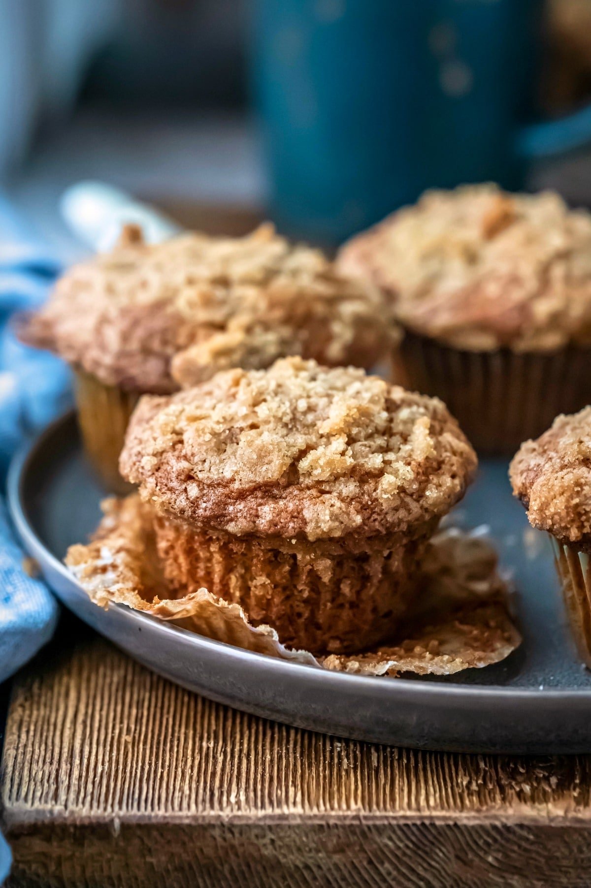 Gray plate with four banana crumb muffins on it