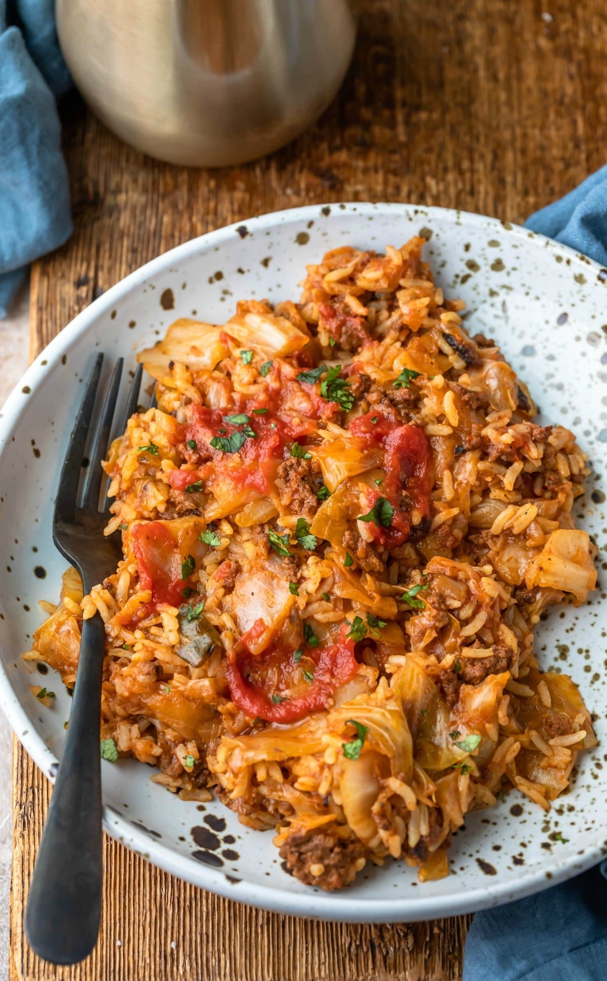 Plate of cabbage roll bowl with a black fork next to it